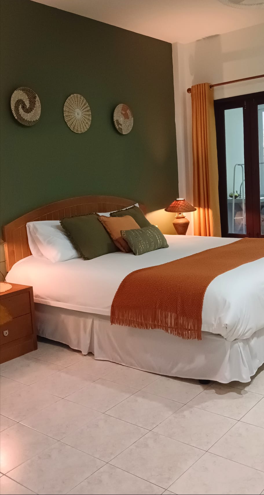 Jungle view room with king bed and green feature wall