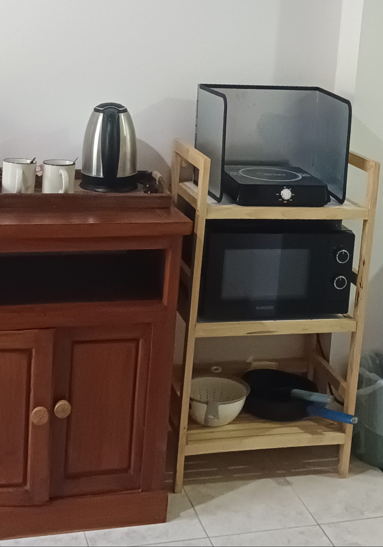 Pool view room kitchenette with induction hob and microwave