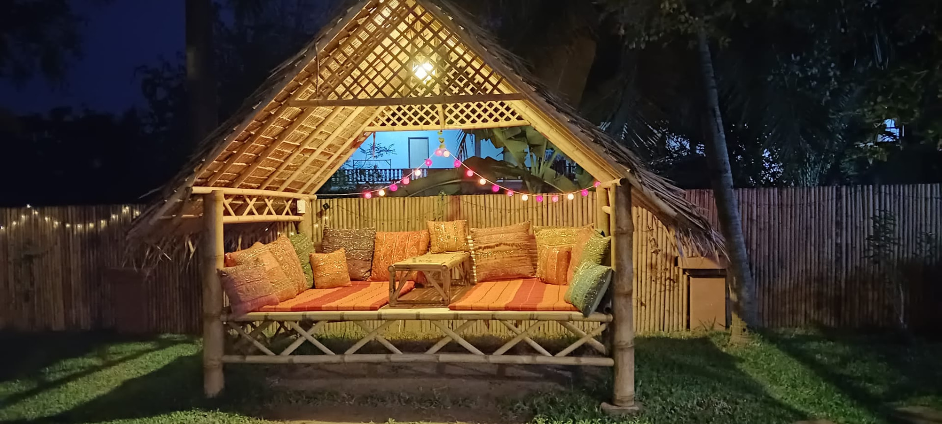 Traditional Thai bamboo sala lit up at night