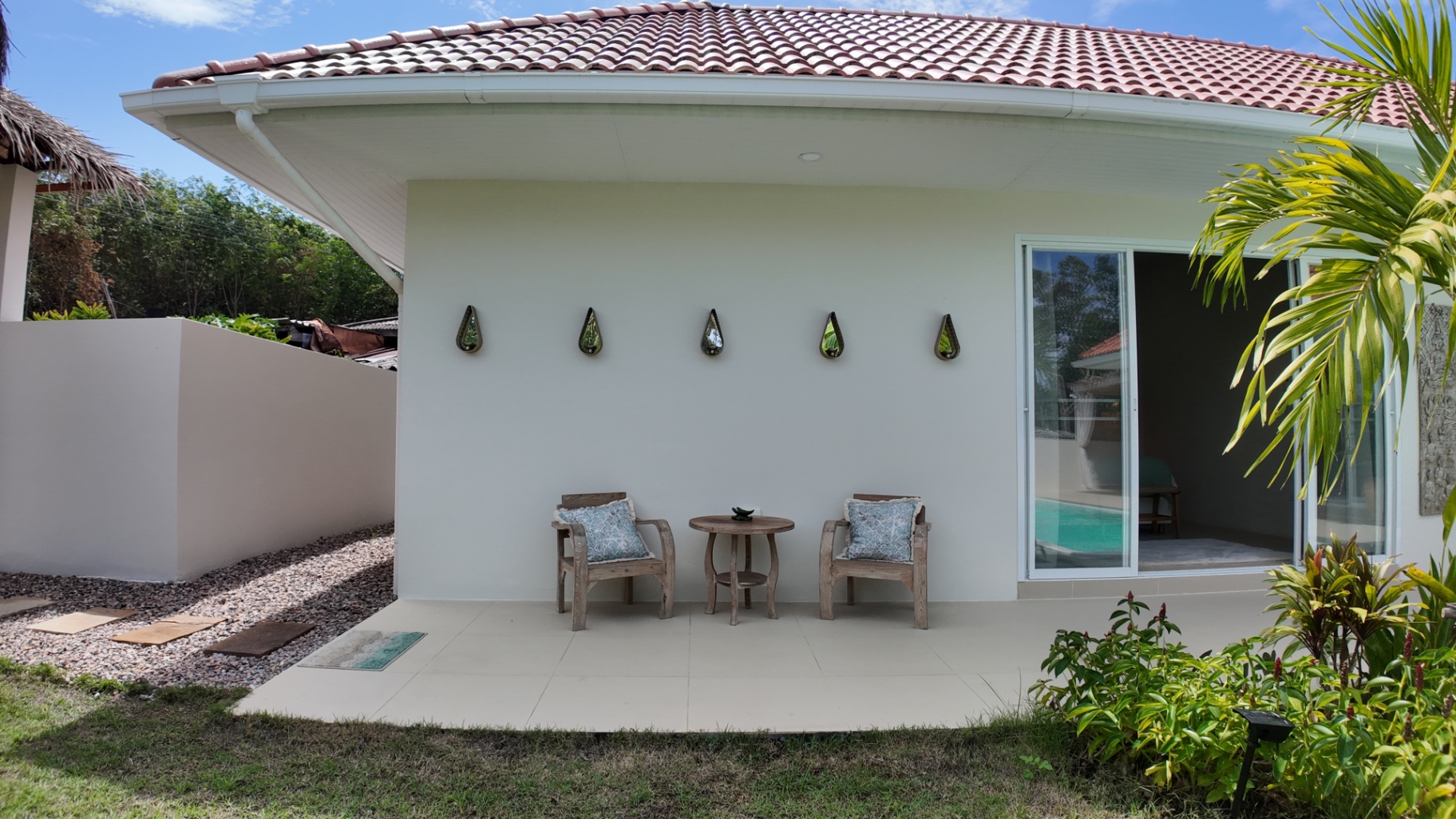 Outdoor table and chairs beside the private pool at Villa Reina