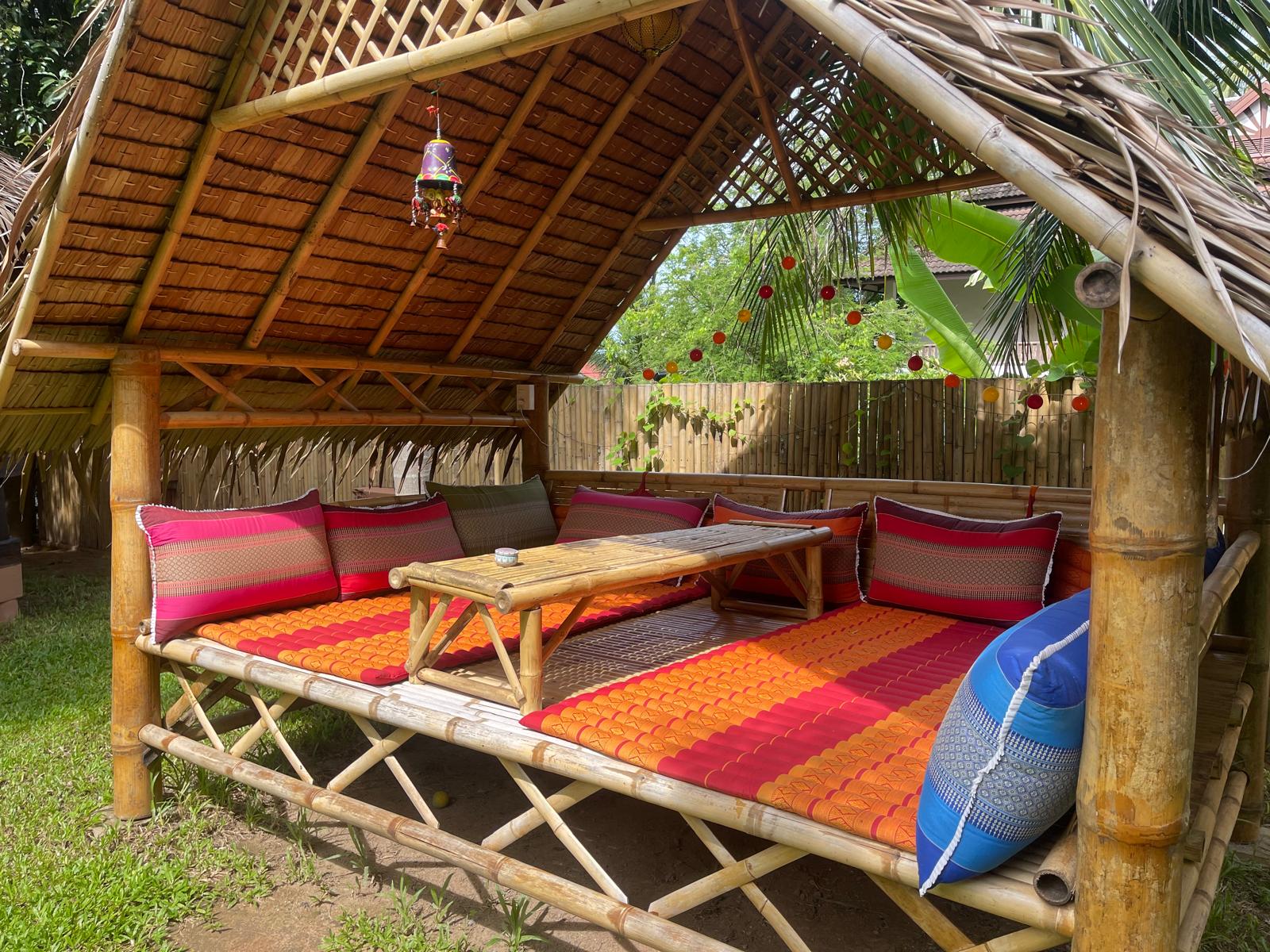 Bamboo daybed sala under a thatched roof
