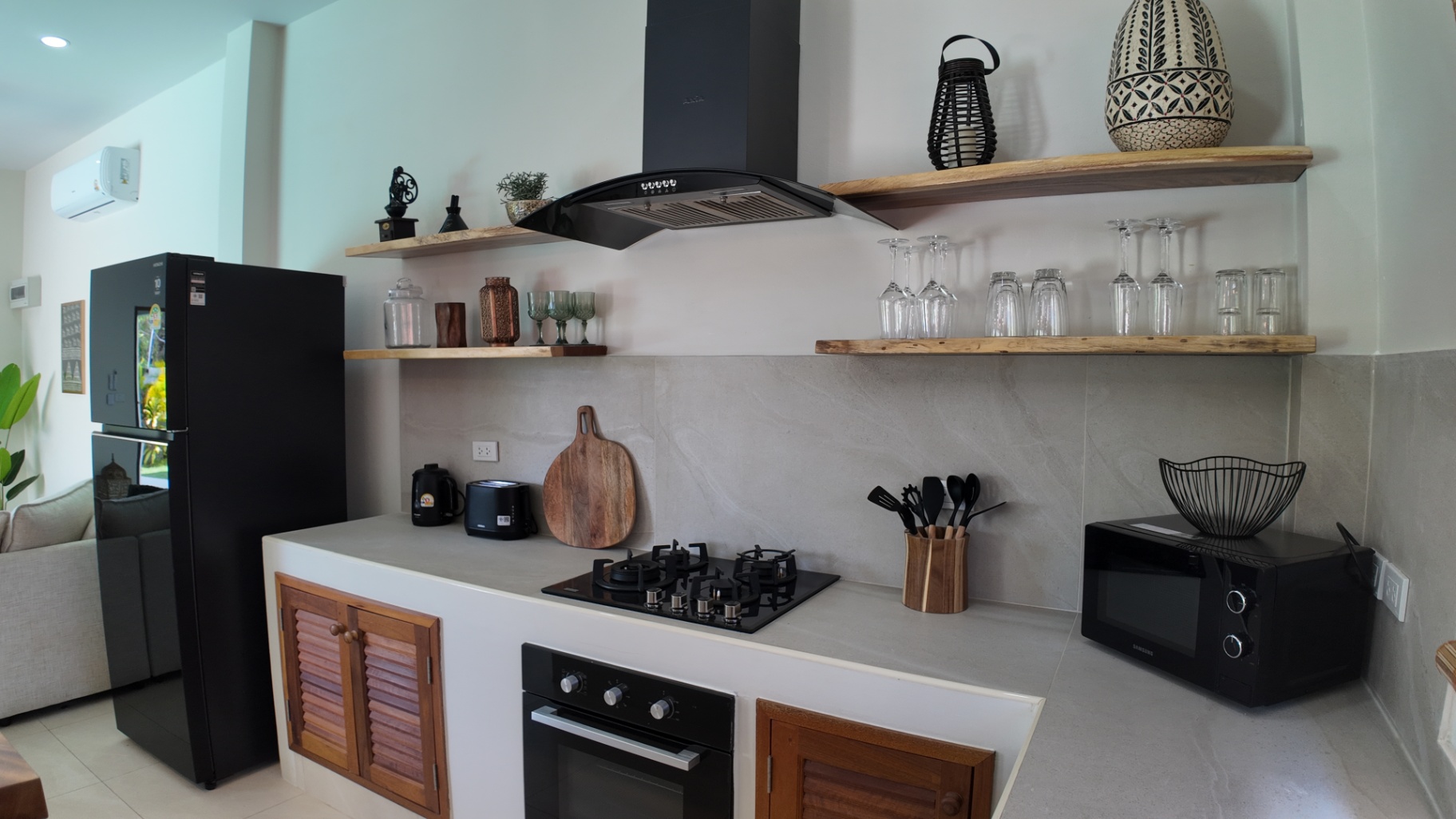 Kitchen overview with natural wood finishes at Villa Reina